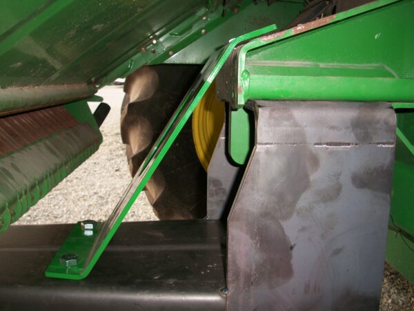 A green tractor with a Combine Tow Hitch for John Deere "STS" Series attached to it.