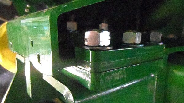 A close up of a green Combine Tow Hitch for JD "S" Series 2013 and newer tractor.