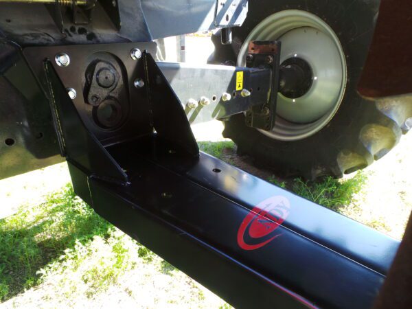 A close up of a black Combine Tow Hitch for Case IH - newer models with a red logo on it.