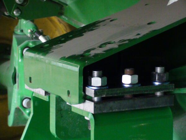 A close up of a Combine Tow Hitch for JD "S" Series 2013 and newer, with bolts on it.