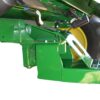 A green Combine Tow Hitch for JD "S" Series 2012 with a front end loader.