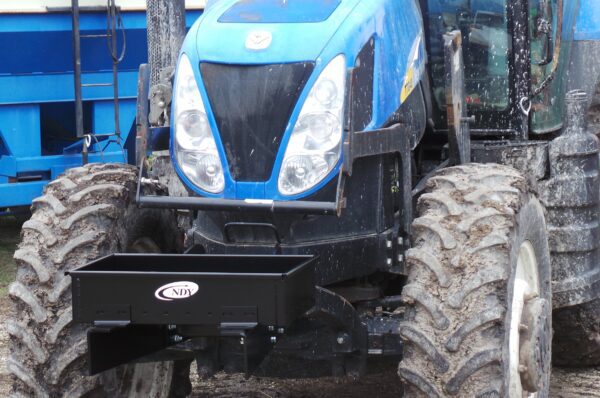 A Rock Box for New Holland T7 Series without Weights tractor parked in the dirt.