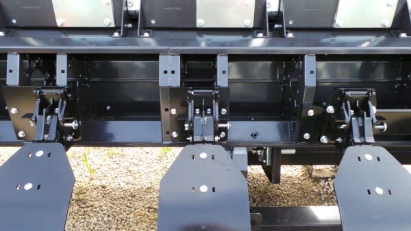 A close up of a Stalk Stomper for Drago GT Series 12 Row 20" Corn Head with a couple of attachments.