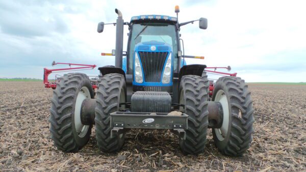 A Rock Box for New Holland for T8 Series tractor in a field.