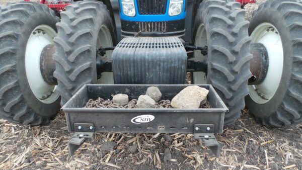 A tractor with a Rock Box for New Holland for T8 Series on it.