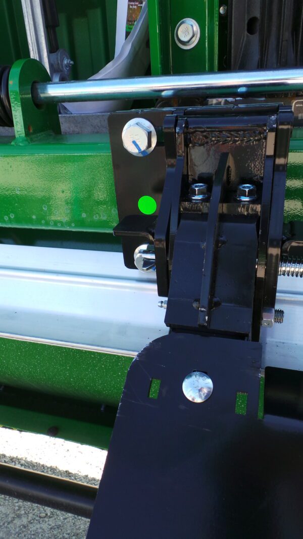 Industrial machinery component with green and black parts.