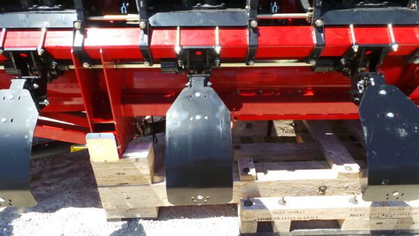 A red Stalk Stompers for Case 4012 Folding and New Holland 980CF-12 Series Corn Head tractor with a pair of blades on it.