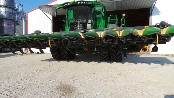 A Stalk Stomper for 6 Row Capello and Lexion Corn Heads parked in front of a building.