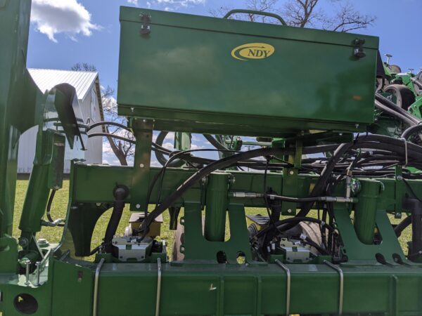 A Large Utility Storage Box for John Deere 1790/95 Planters with Interplant with a lot of wires attached to it.