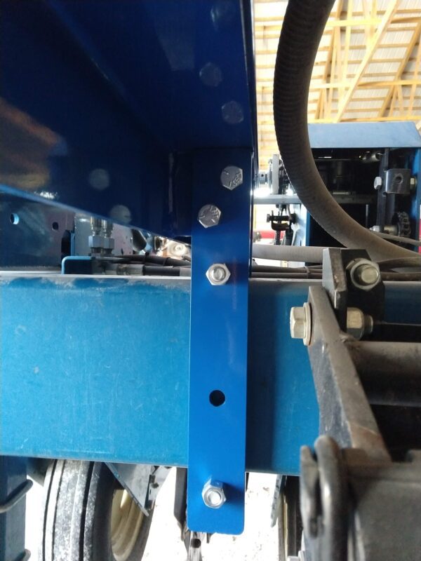 A close up of a Mounting Bracket Kit for Large Utility Box - fits Kinze 3600 & 3660 Planters tractor with a metal frame.