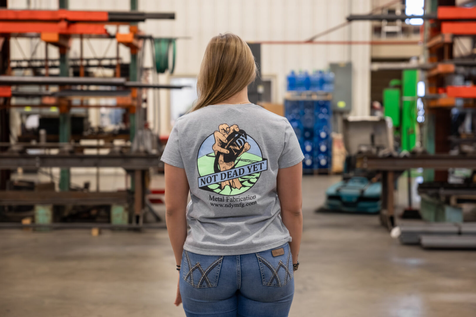 Person in workshop wearing slogan t-shirt.