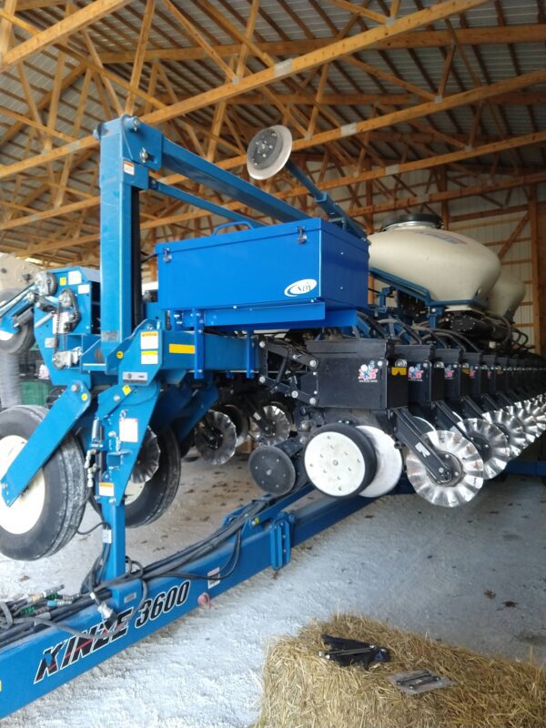 A Large Utility Storage Box for 3600 and 3660 Series Kinze Planters is sitting in a barn.