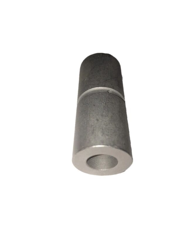 A gray metal greaseable interior bushing with a hole in it.