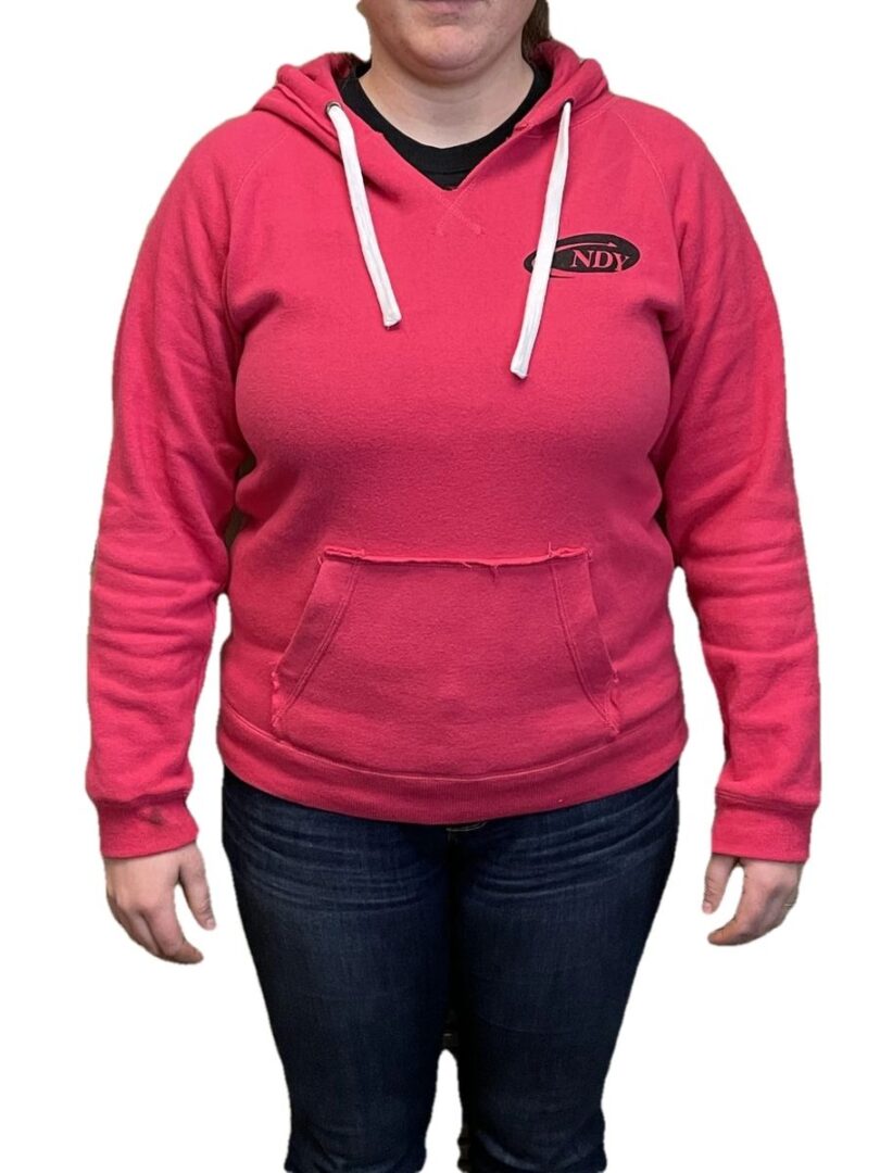 A woman wearing a NDY Hooded Sweatshirt - Women's and jeans.