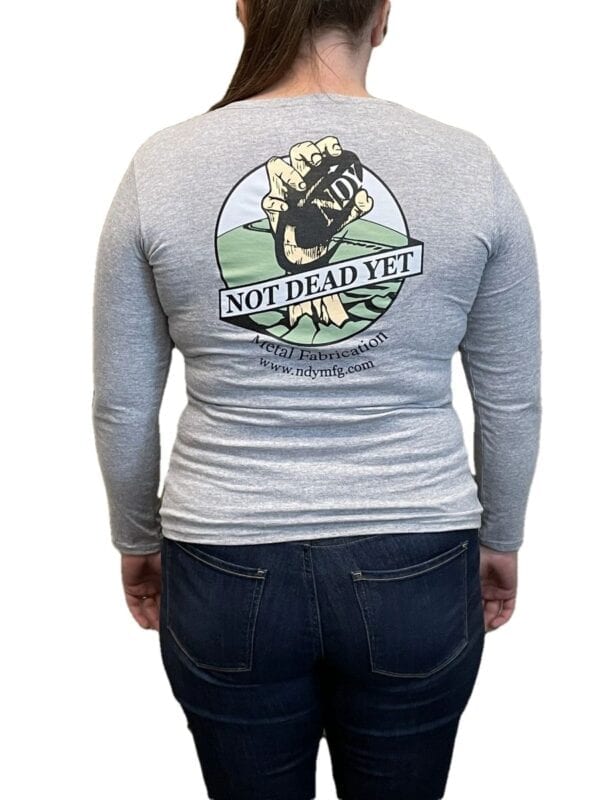 The back of a woman wearing an NDY Long Sleeve Women's T-shirt that says not dead yet.