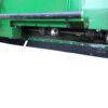 A green Skirt Kit for John Deere 612/712 - 30 inch row spacing machine with a blade attached to it.