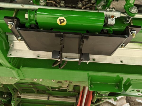 Green hydraulic mechanism with black mounting bracket.
