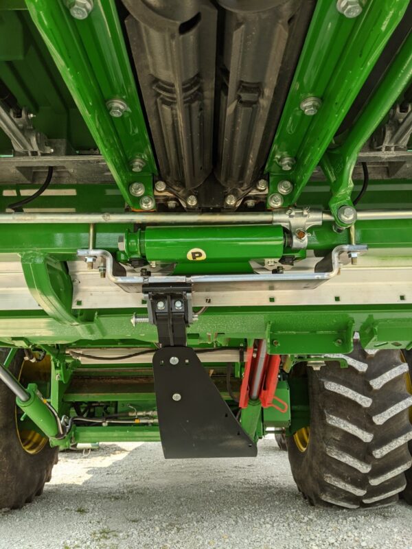 Underneath view of green agricultural machinery.