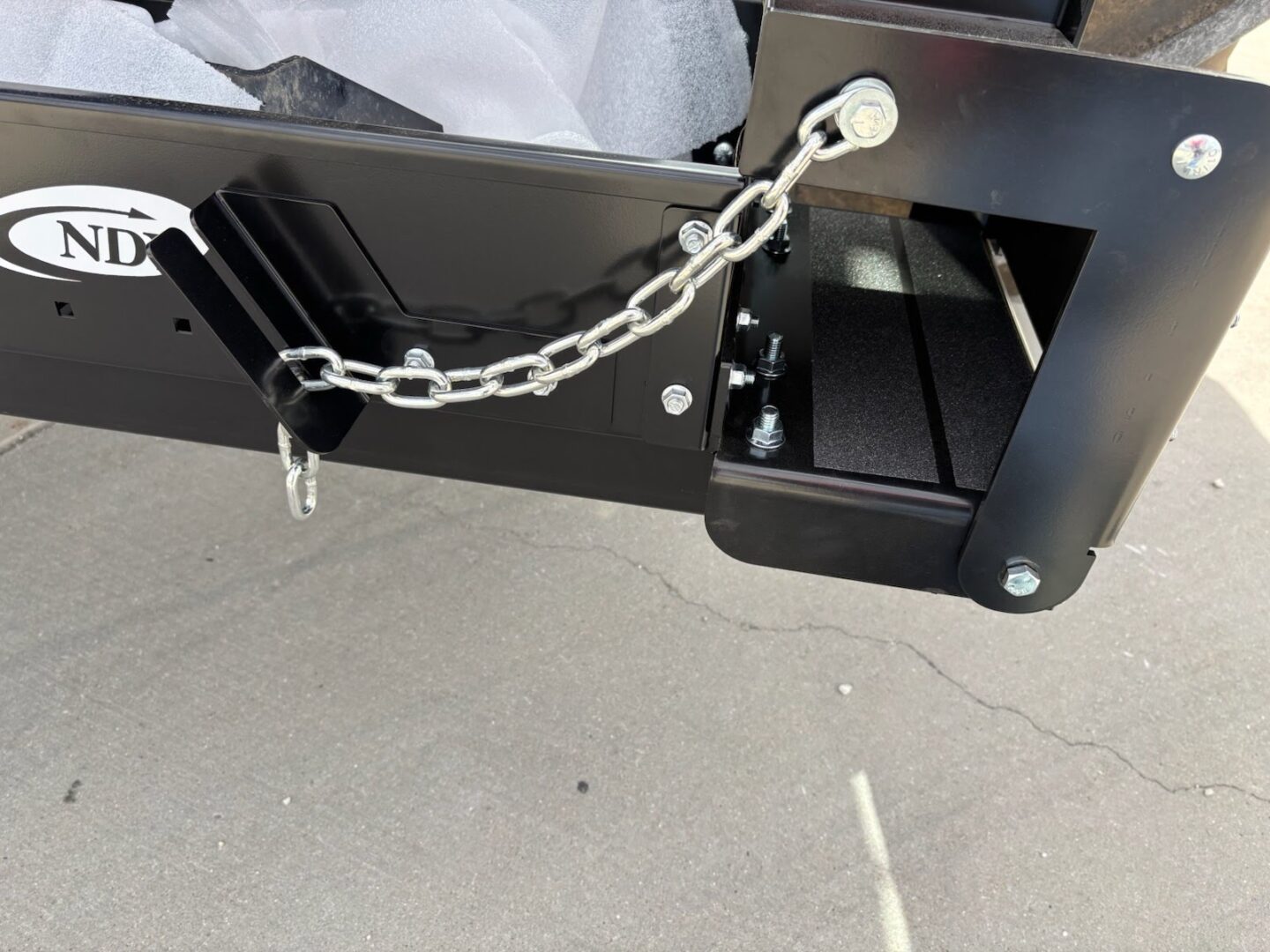 Metal mechanism with chain and bolts attached.
